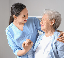 IMAGE 2 — Physiotherapist assisting patient with dumbbell exercise