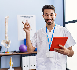 IMAGE 6 — Therapist consulting with patient using a tablet